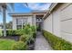 Front entry with walkway, landscaping, and decorative lighting at 7153 Drewrys Blf, Bradenton, FL 34203