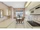 Eat-in kitchen with white cabinets and a view to the backyard at 7153 Drewrys Blf, Bradenton, FL 34203