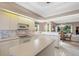 Spacious kitchen with white cabinets, island, and adjacent laundry room at 7153 Drewrys Blf, Bradenton, FL 34203
