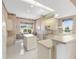 Well-equipped kitchen with an island, white cabinets, and tile flooring at 7153 Drewrys Blf, Bradenton, FL 34203