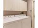 Laundry room with washer, dryer, and upper cabinets at 7153 Drewrys Blf, Bradenton, FL 34203