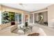 Open living room with curved sofa and glass coffee table at 7153 Drewrys Blf, Bradenton, FL 34203