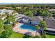 Aerial view showing community pool, building, and lush landscaping at 7312 Cloister Dr # 7312, Sarasota, FL 34231