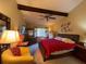 Main bedroom with a red bedspread and a ceiling fan at 7312 Cloister Dr # 7312, Sarasota, FL 34231