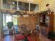 Bright dining area with a glass table, wooden chairs, and access to a patio at 7312 Cloister Dr # 7312, Sarasota, FL 34231