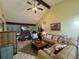 Open living room with sectional sofa and wood-look flooring at 7312 Cloister Dr # 7312, Sarasota, FL 34231