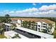 Exterior view of condo building with covered parking and manicured landscaping at 8735 Olde Hickory Ave # 8108, Sarasota, FL 34238