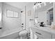 Modern bathroom with marble tile, a bathtub, and a white vanity at 11216 Coralbean Dr, Lakewood Ranch, FL 34202