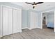 Bedroom with white closet doors and wood flooring at 11216 Coralbean Dr, Lakewood Ranch, FL 34202