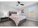 Bedroom with floral bedding, ceiling fan, and wood-look floors at 11216 Coralbean Dr, Lakewood Ranch, FL 34202