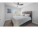 Bedroom with teal bedding, ceiling fan, and large window at 11216 Coralbean Dr, Lakewood Ranch, FL 34202