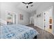 Bright bedroom with a patterned bedspread and access to a private bathroom at 11216 Coralbean Dr, Lakewood Ranch, FL 34202