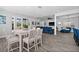 Open dining area with a modern table and chairs, overlooking the living room at 11216 Coralbean Dr, Lakewood Ranch, FL 34202