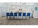 Modern kitchen with white cabinets, a large island, and blue barstools at 11216 Coralbean Dr, Lakewood Ranch, FL 34202