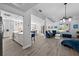 Modern kitchen with white cabinets, a large island, and blue barstools at 11216 Coralbean Dr, Lakewood Ranch, FL 34202