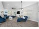 Bright living room with blue sectional sofa and hardwood floors at 11216 Coralbean Dr, Lakewood Ranch, FL 34202