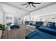 Open living room with blue furniture and hardwood floors at 11216 Coralbean Dr, Lakewood Ranch, FL 34202