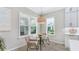 Cozy kitchen nook with a round glass table and wicker chairs at 12018 Thornhill Ct, Lakewood Ranch, FL 34202