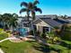 Single-Gathering home with a metal roof, lush landscaping, and a private pool at 1223 Via Tripoli, Punta Gorda, FL 33950