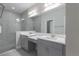 Double vanity bathroom with a large mirror and shower at 12513 Oak Hill Way, Parrish, FL 34219