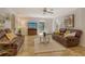 Living room with brown couches, tile floors, and a TV at 1905 Jasmine Dr, Sarasota, FL 34239