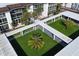 Aerial view highlighting lush courtyard, modern walkways, and manicured grounds at 2110 Benjamin Franklin Dr # 108, Sarasota, FL 34236