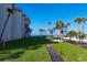 Expansive lawn bordered by palm trees and leading to a beautiful ocean view at 2110 Benjamin Franklin Dr # 108, Sarasota, FL 34236