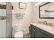 Cozy bathroom featuring a granite vanity, framed mirror, toilet and a glass enclosed shower at 2431 Golf Course Dr # 703, Sarasota, FL 34234