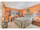 Bedroom with queen bed, orange walls, and ample natural light at 2431 Golf Course Dr # 703, Sarasota, FL 34234