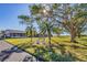 Well-kept exterior view with tidy landscaping and a seating bench at 2431 Golf Course Dr # 703, Sarasota, FL 34234