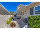 Exterior view of a walkway bordered by lush landscaping and a carport at 2431 Golf Course Dr # 703, Sarasota, FL 34234