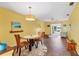 The living room features stylish seating, a ceiling fan and sliding glass doors to the patio at 2431 Golf Course Dr # 703, Sarasota, FL 34234