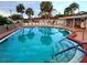 Community swimming pool with plenty of lounge chairs at 2431 Golf Course Dr # 703, Sarasota, FL 34234