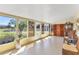 Bright sunroom with large windows, tile floor, and comfortable seating area at 2431 Golf Course Dr # 703, Sarasota, FL 34234