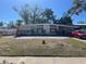 Mid-century modern home with light blue exterior and stone accents at 3068 Courtland St, Sarasota, FL 34237