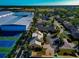 Aerial view of a community with tennis courts and residential homes at 3607 57Th Avenue W Dr, Bradenton, FL 34210