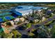 Aerial view showcasing a community near tennis courts and large buildings at 3607 57Th Avenue W Dr, Bradenton, FL 34210