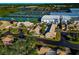 Aerial view of residential homes and tennis courts in a community at 3607 57Th Avenue W Dr, Bradenton, FL 34210