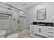 Bathroom featuring a walk-in shower, black vanity, and marble floors at 3607 57Th Avenue W Dr, Bradenton, FL 34210