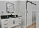 Modern bathroom with a black marble countertop and barn door at 3607 57Th Avenue W Dr, Bradenton, FL 34210