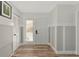 Bright entryway with white door, wood-look floors, and built-in storage at 3607 57Th Avenue W Dr, Bradenton, FL 34210