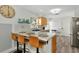 Modern kitchen with light wood cabinets, quartz countertops, and stainless steel appliances at 3607 57Th Avenue W Dr, Bradenton, FL 34210