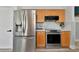 Stainless steel appliances and light wood cabinets in this updated kitchen at 3607 57Th Avenue W Dr, Bradenton, FL 34210