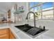 Modern kitchen with sink, dishwasher and a window overlooking the backyard at 3607 57Th Avenue W Dr, Bradenton, FL 34210