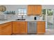 Modern kitchen with light wood cabinets, updated countertops, and a dishwasher at 3607 57Th Avenue W Dr, Bradenton, FL 34210