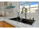 Modern kitchen sink with a sleek faucet and marble countertop at 3607 57Th Avenue W Dr, Bradenton, FL 34210