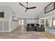 Bright living room with sectional sofa, wood-look floors, and access to a sunroom at 3607 57Th Avenue W Dr, Bradenton, FL 34210