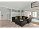 Spacious living room with sectional sofa, wood-look floors, and access to a sunroom at 3607 57Th Avenue W Dr, Bradenton, FL 34210