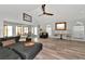Open living space with sectional sofa, wood floors, and a casual dining area at 3607 57Th Avenue W Dr, Bradenton, FL 34210