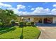 Front view of charming single-story home with lush lawn and carport at 390 301 W Blvd # 30D, Bradenton, FL 34205